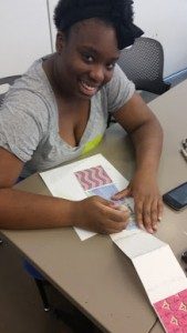 A Launch participant working on her accordion book project in one of Crystal Bridges' studios.