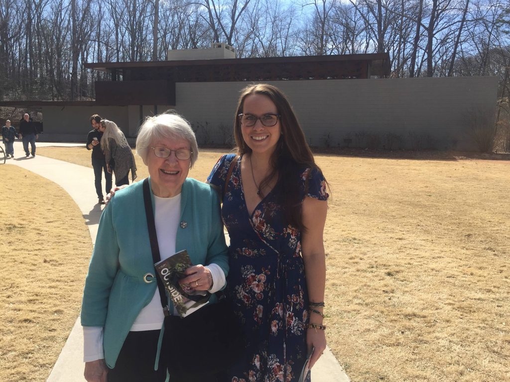 a mom and daughter visitors pose in front of the frank lloyd wright house