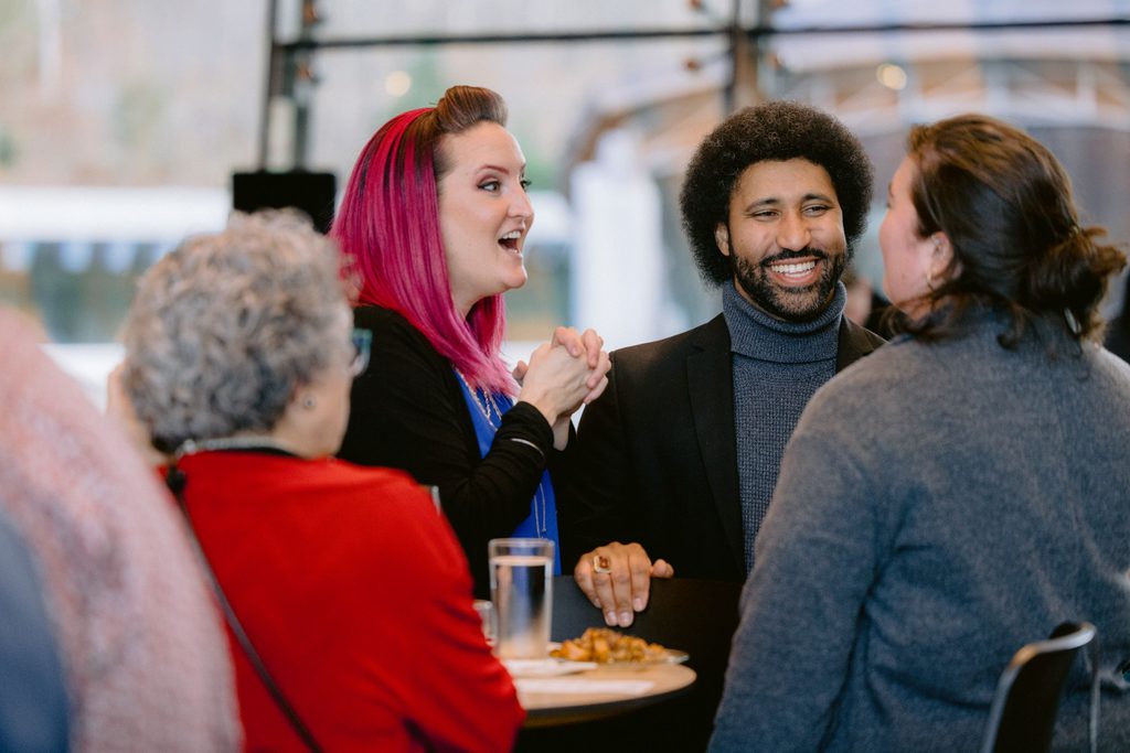 Guests sitting around a table laughing together