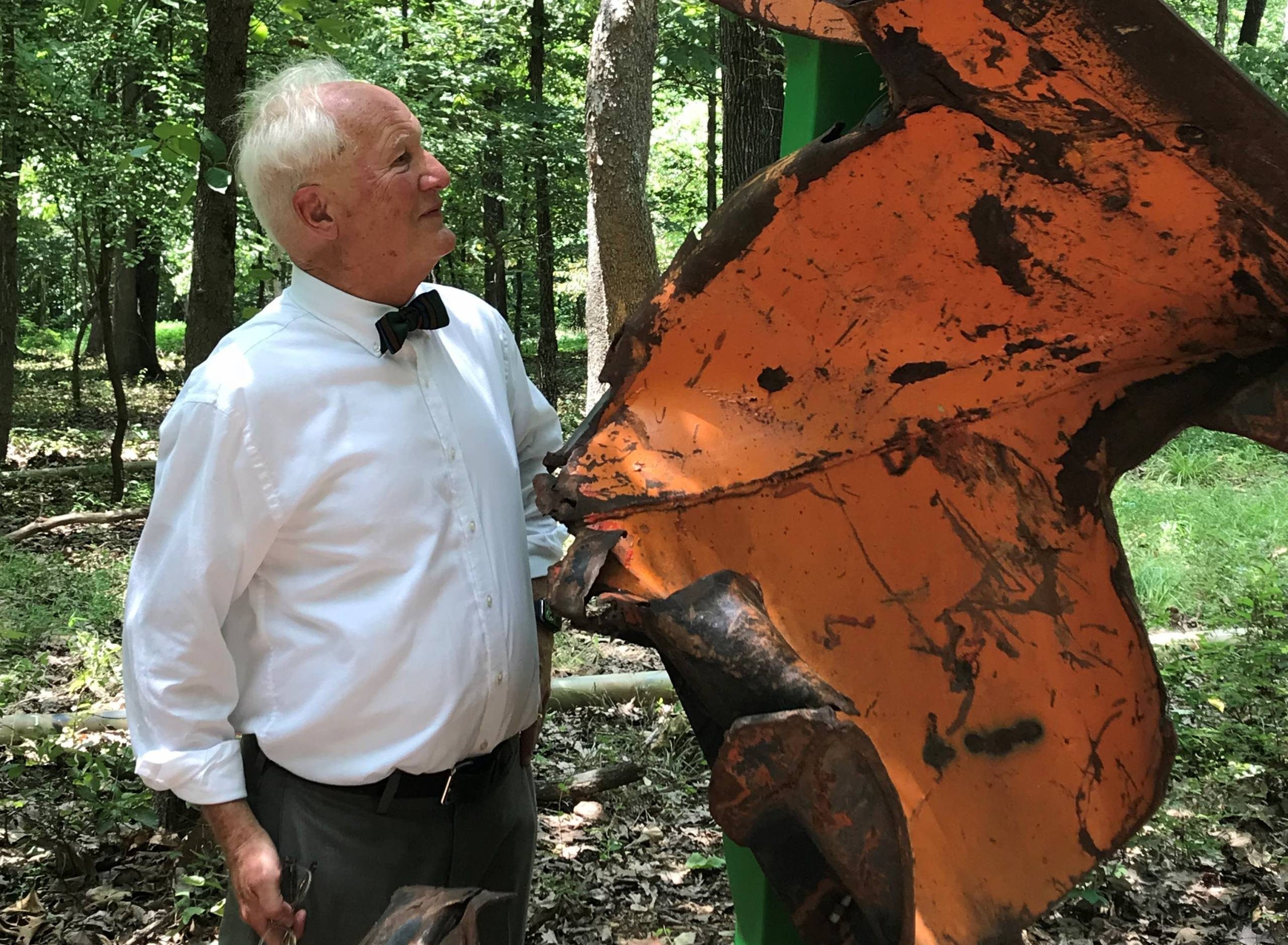volunteer Bill Correll with outdoor artwork