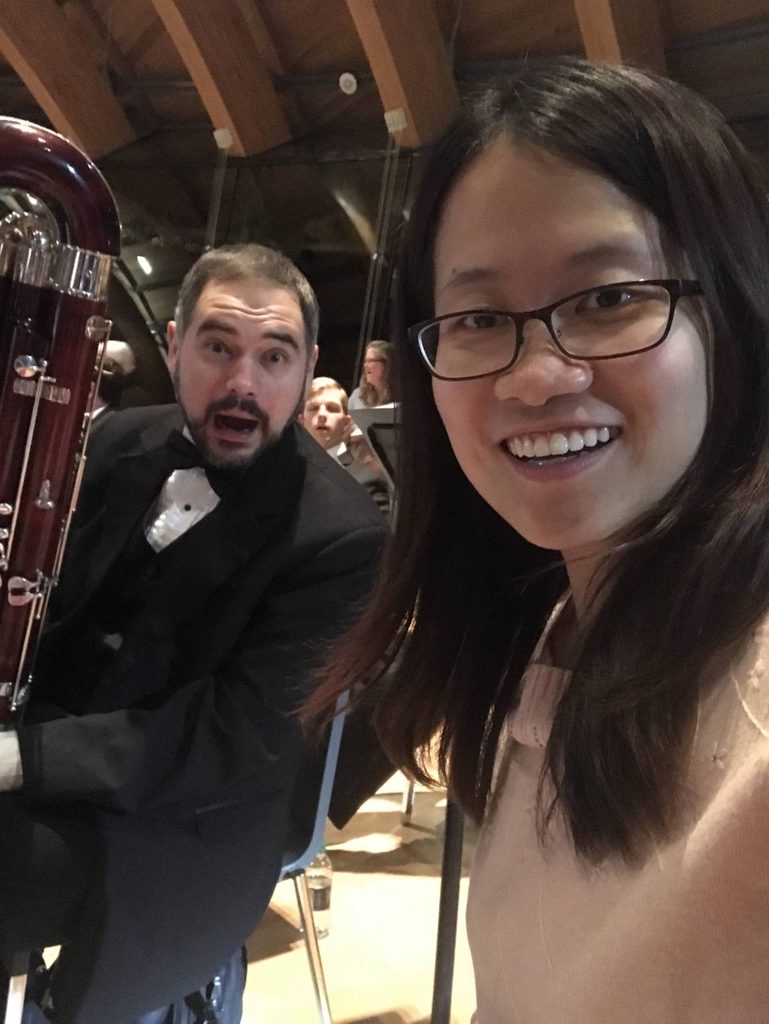 two musicians take a photo in the great hall with their bassoons