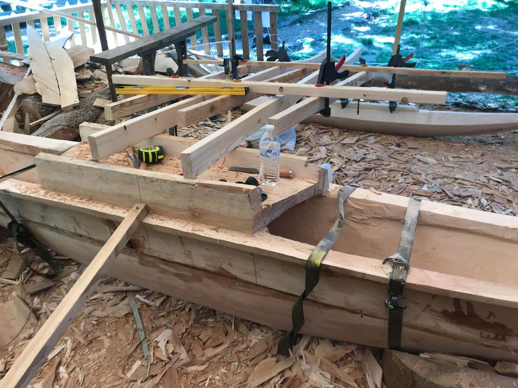 Unfinished canoe being built in wood