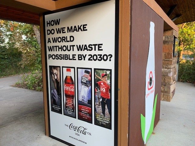 Coca-Cola ad promoting a waste-free world by 2030 with images of recycling and sustainability.