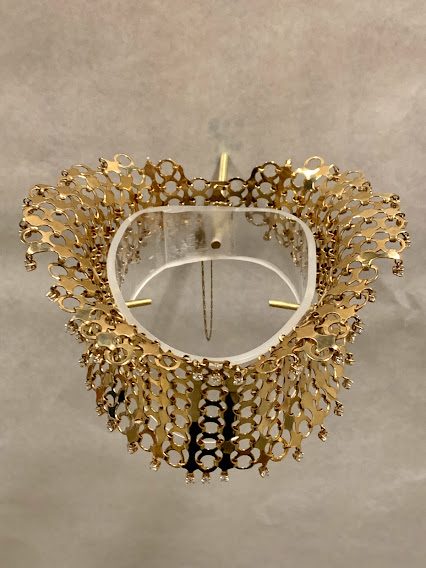 mount supporting the jewelry artwork called Neck Lace by Mary Ann Scherr, seen in Crafting America