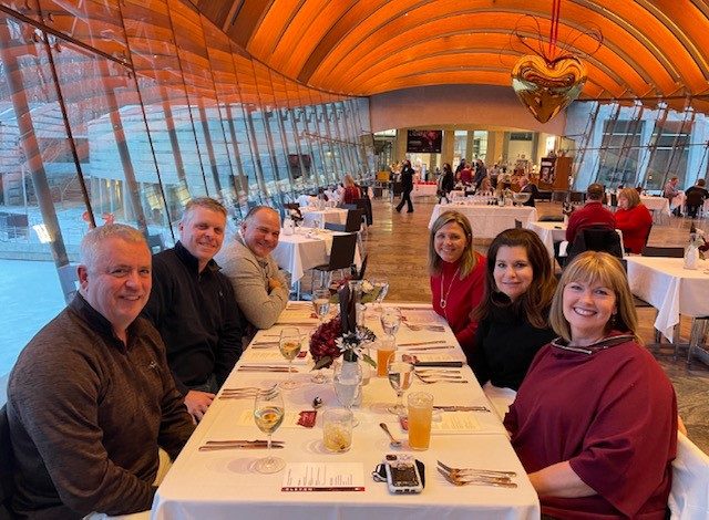 a group of friends eat dinner in eleven