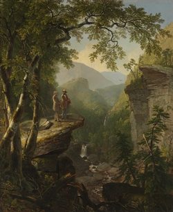 Two men on a rocky ledge overlook a lush valley with trees and distant waterfall in warm light.