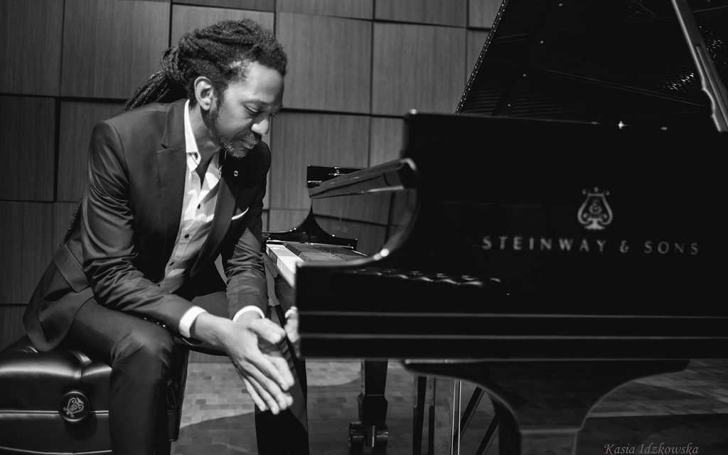 Elio Villafranca sitting in front of a piano