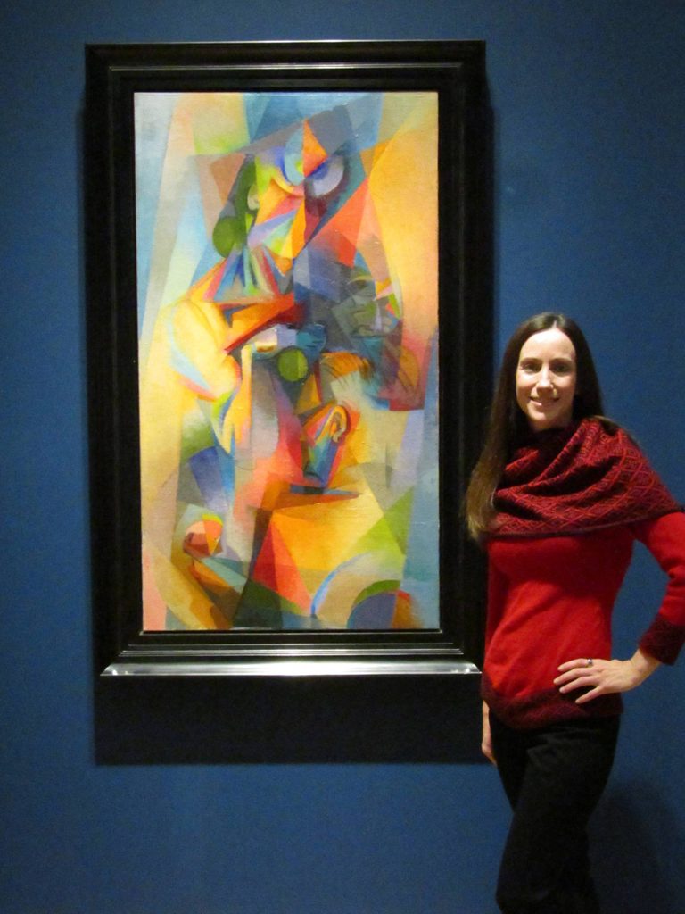 a volunteer poses with an artwork in the modern art gallery
