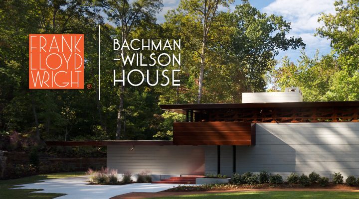 Bachman-Wilson House by Frank Lloyd Wright amidst lush trees and greenery.