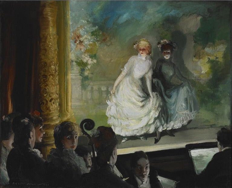 Two women perform on stage in elegant dresses with audience and ornate décor.