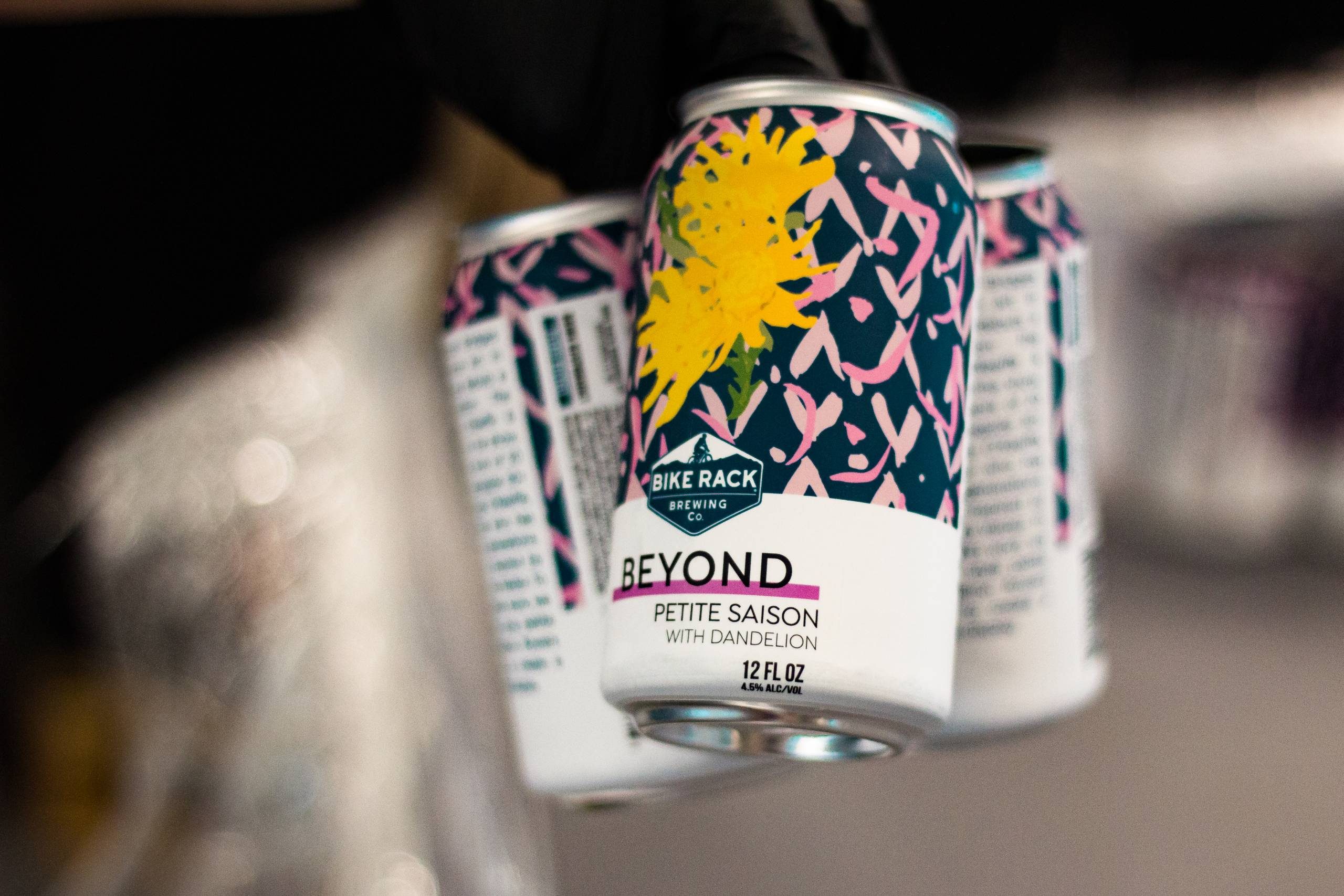 Can of Beyond Petite Saison beer with dandelion, 12 fl oz, 4.5% ABV, colorful design.