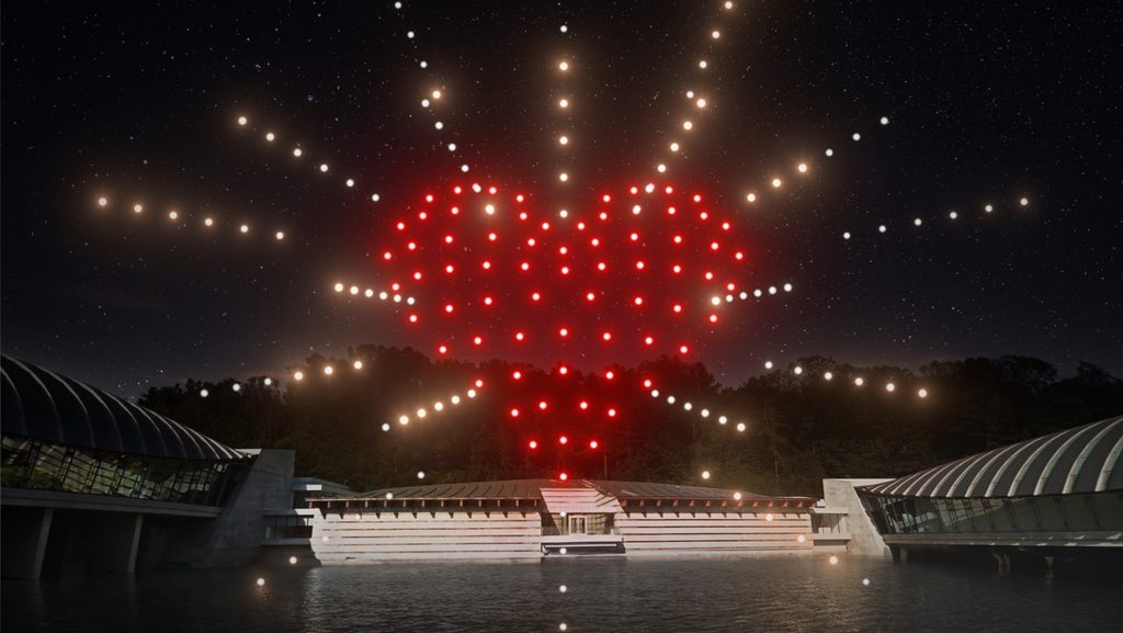 Rendering depicting a red heart with yellow dotted lines surrounding it above Crystal Bridges building