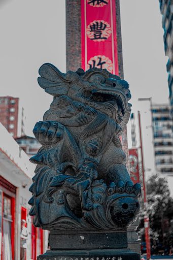 statue of a chinese guardian lion with a ball