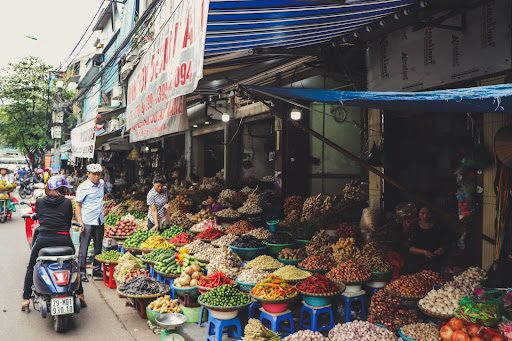 a vietnam food market with bowls of colorful vegetables and grains