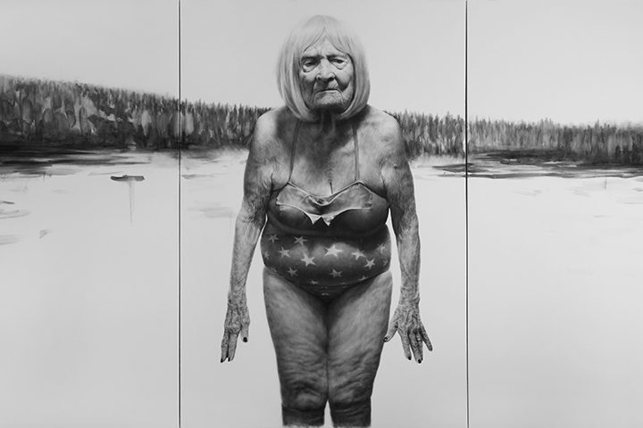 Elderly person in star swimsuit by water, forest background, black and white image.