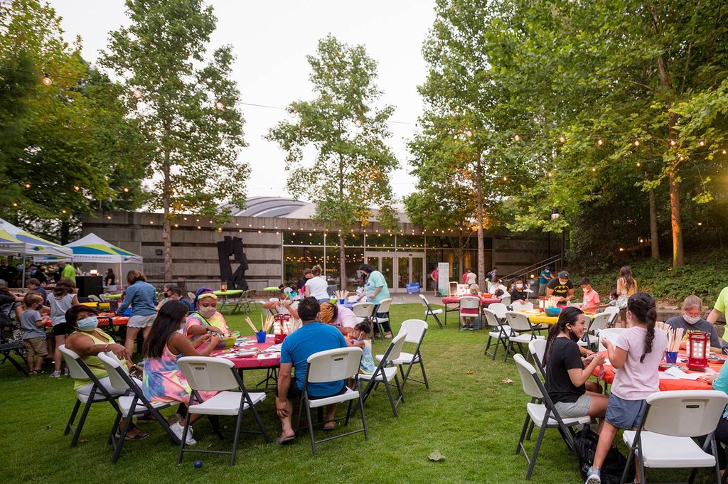 Families making art on the museum grounds