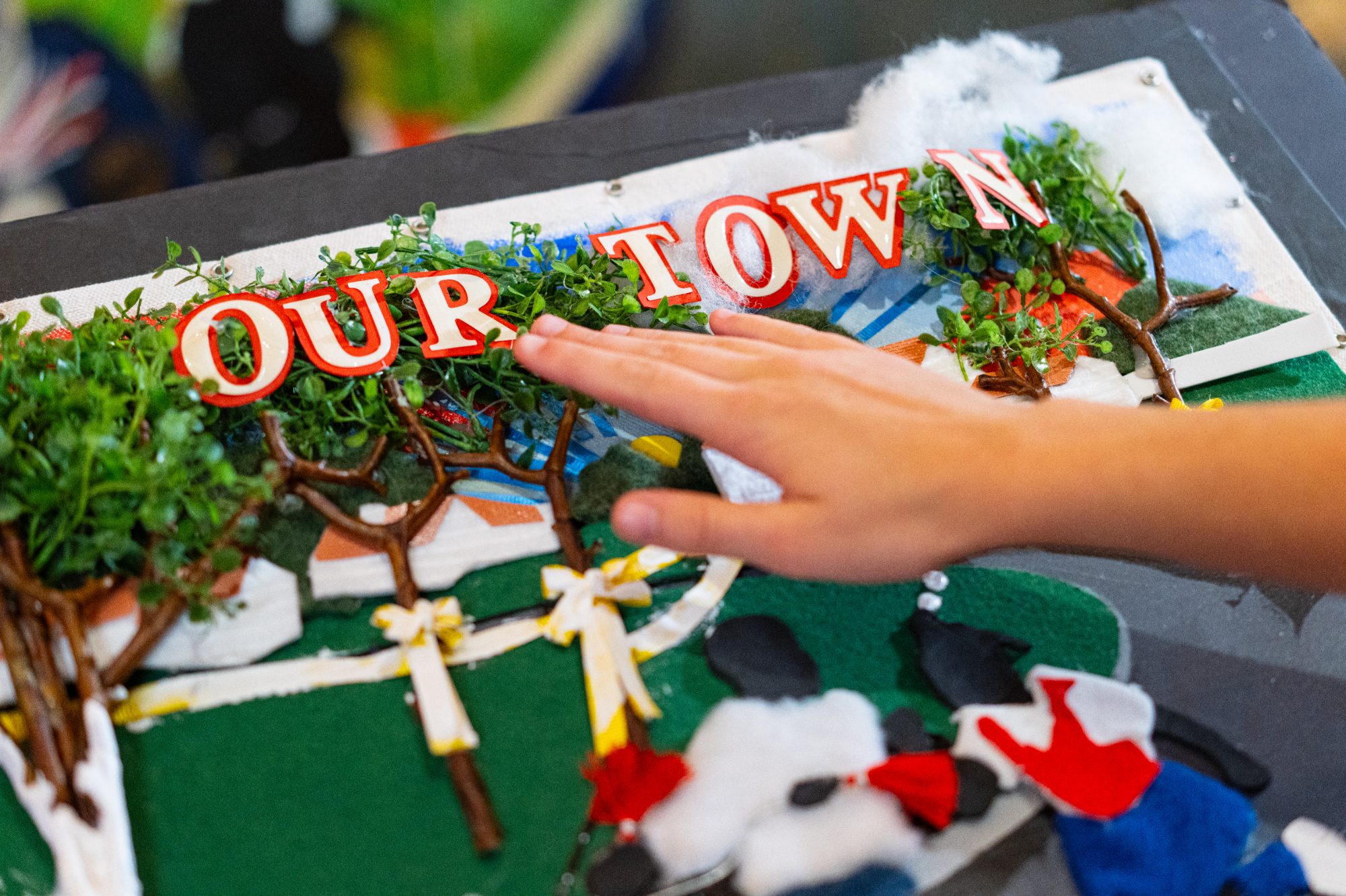 Child's hand touching tactile 