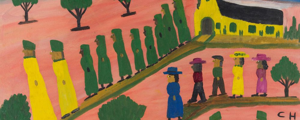 Group of people walking towards a church, trees in background, near a body of water.