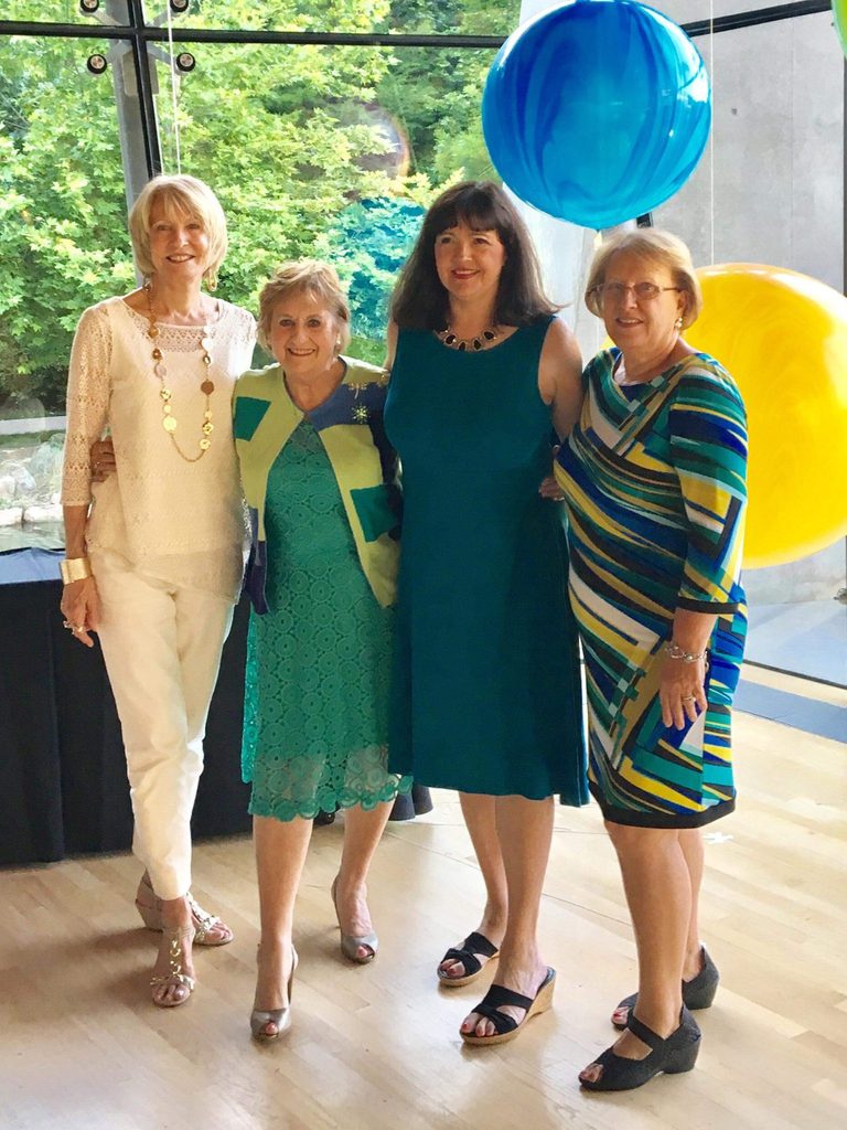 picture of guest services associate sally clifton with three other women in the great hall