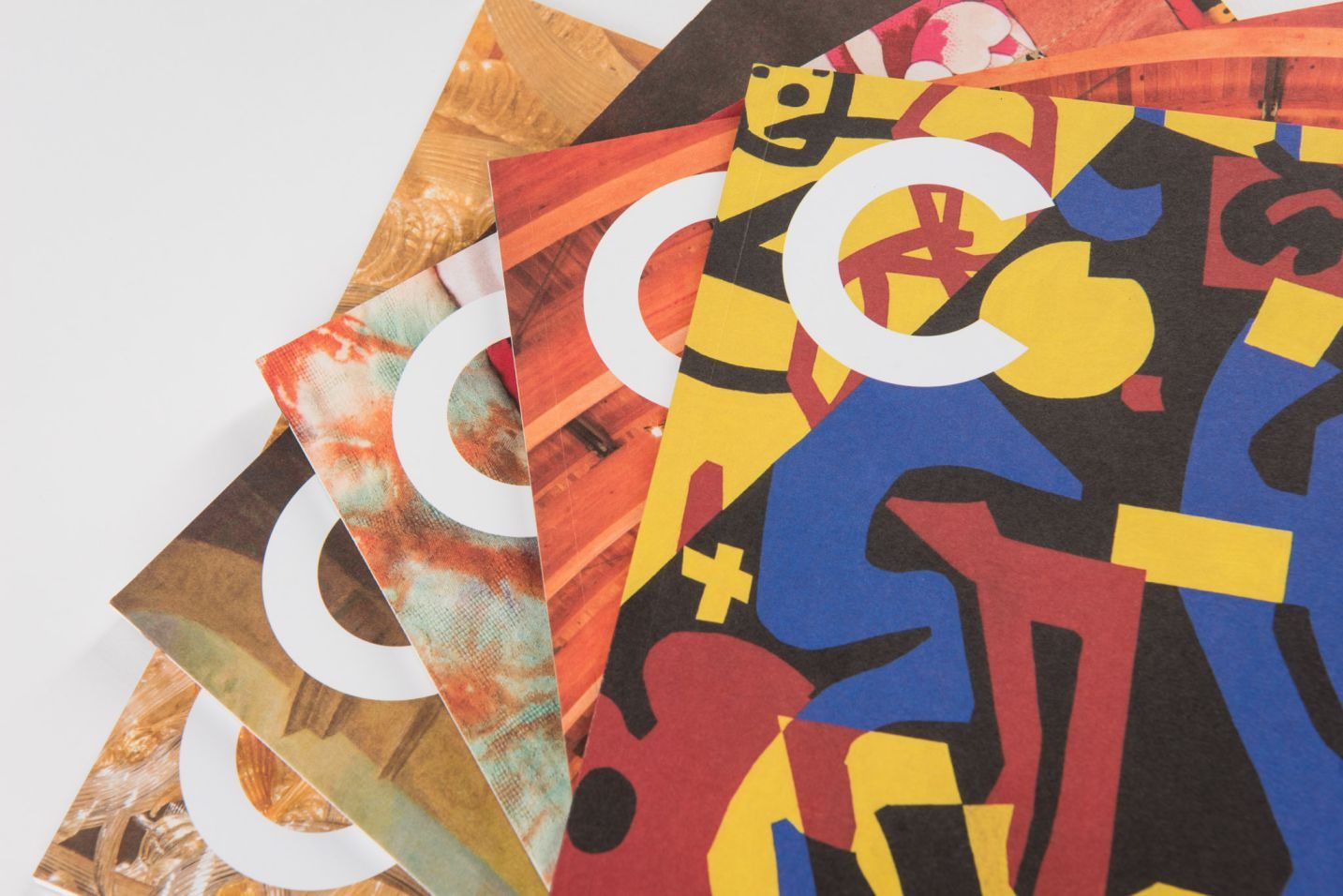 Colorful abstract-patterned booklets with a large white 