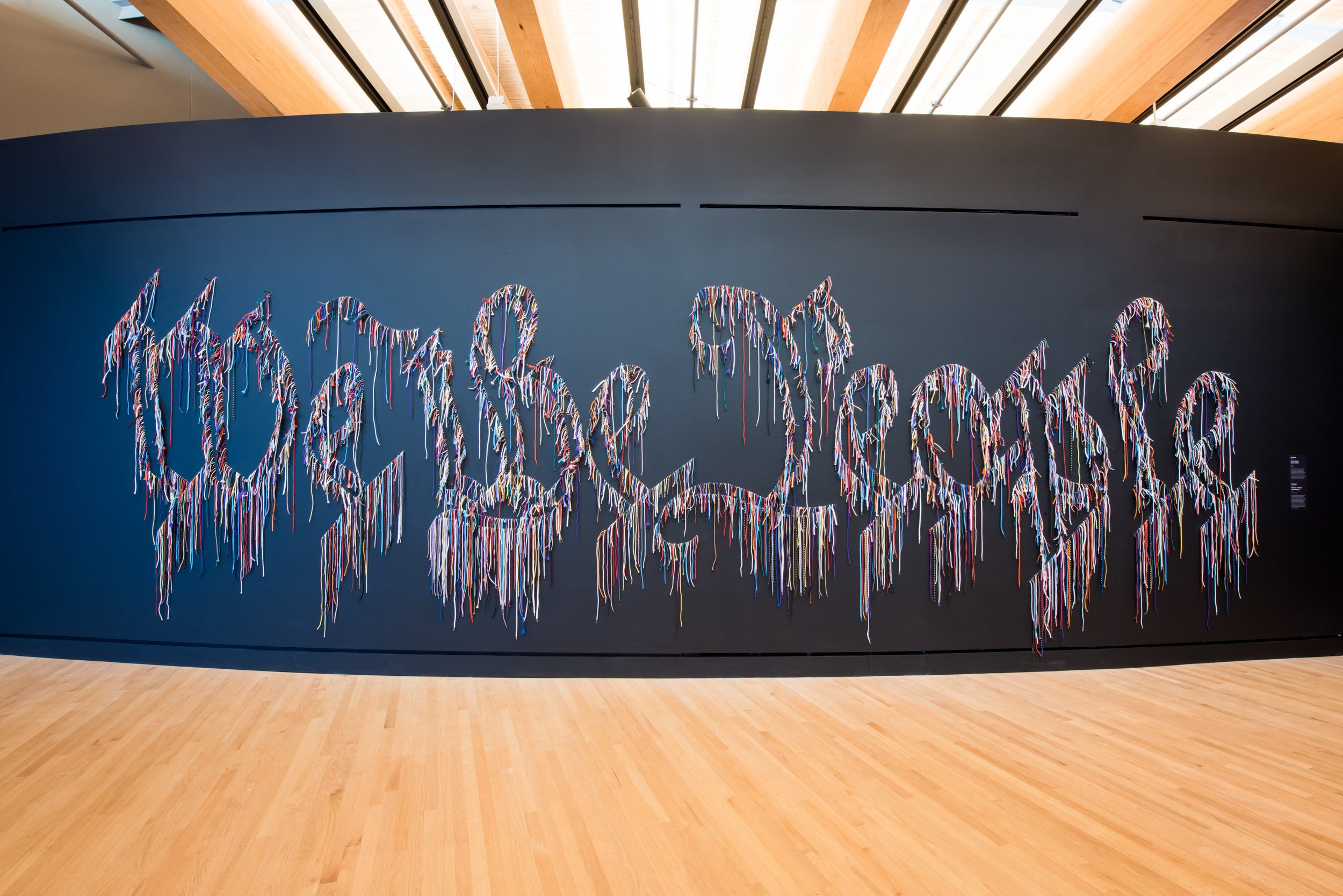 Multicolored string art spelling 