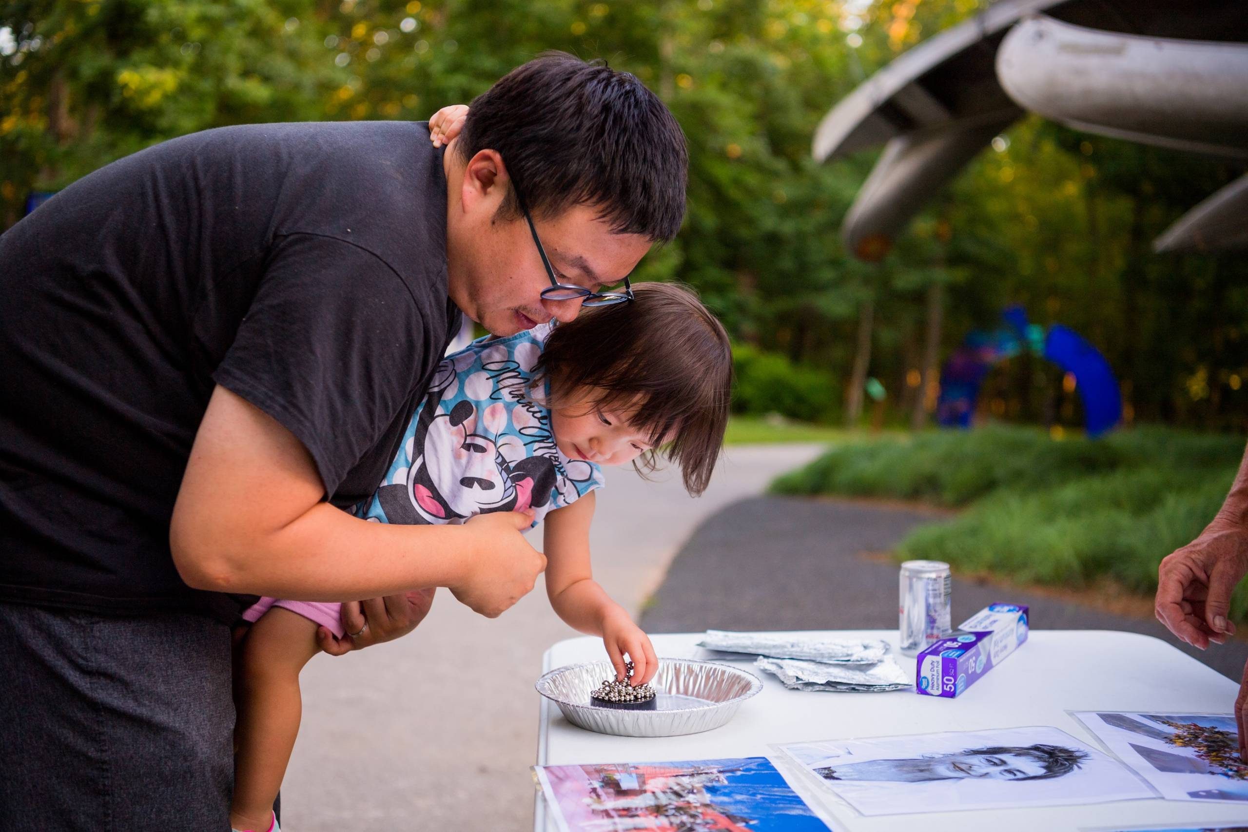 Adult helping child make art