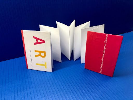 make your own sketchbook art activity; this image features an accordion-folded sketchbook made from paper