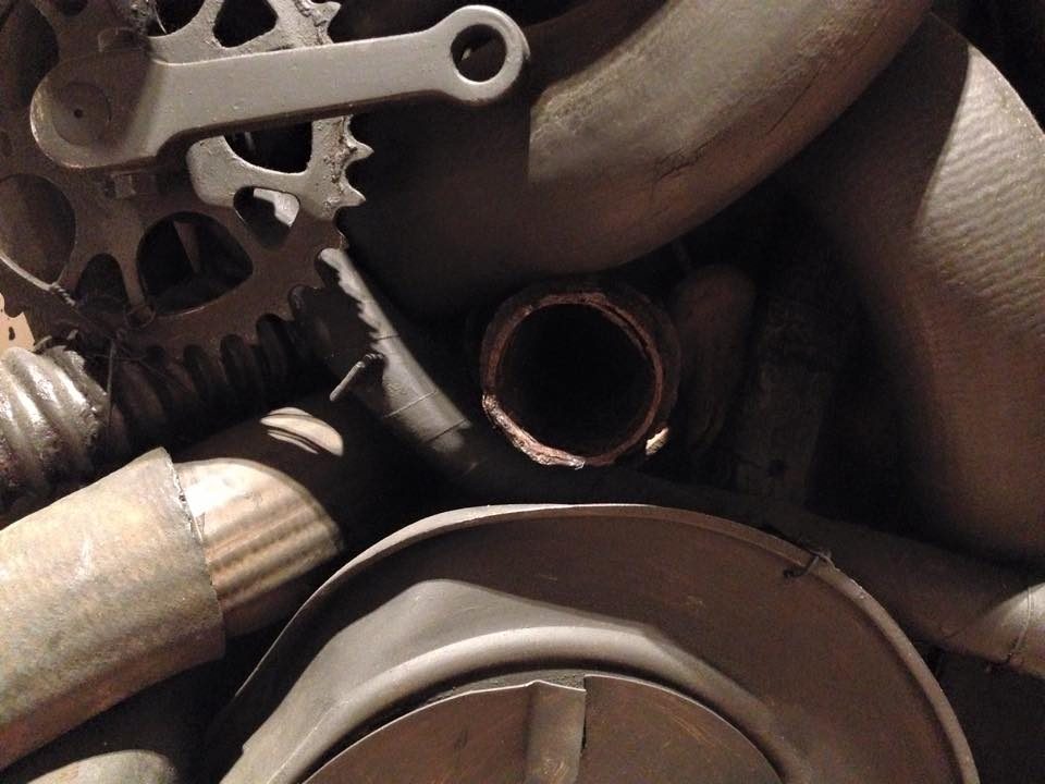 Assortment of aged mechanical parts and corroded metal components in a close-up view.