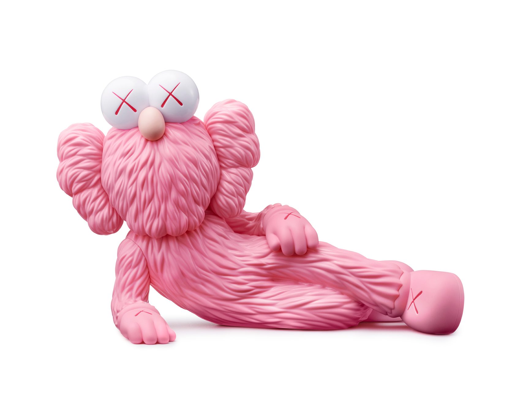 A pink sculpture of a figure laying down in the style of the artist KAWS.