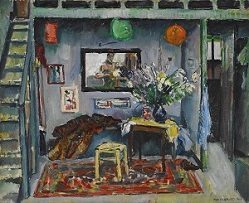 Cozy room with a staircase, table with flowers, art, mirror, and colorful rug. Warm lighting.