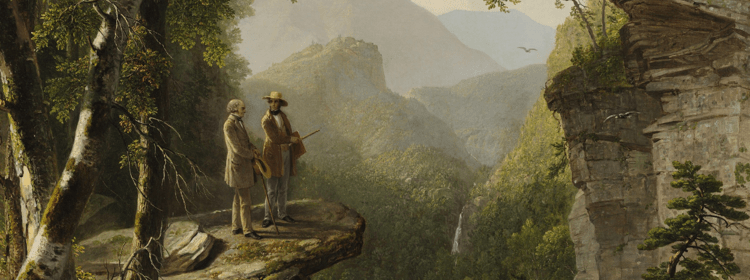 Two men on rocky cliff with sketchbook, view of mountains, trees, and waterfall in background.